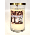 Glass jar candle with a gold lid and amber oud label