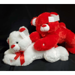 Two plush teddy bears, one white and one red, with ribbons