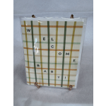 Plaid welcome sign in a clear acrylic holder
