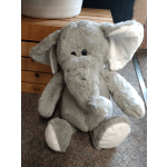 Gray plush elephant toy with white ears and feet