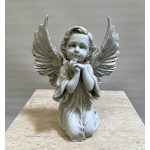 Stone angel figurine with folded hands and large wings