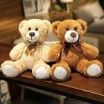 Two teddy bears sitting side by side on a table