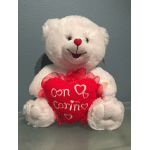 White teddy bear holding a red heart pillow