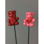 Two glitter teddy bear picks, one red and one pink, on stems