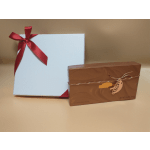 Two gift boxes, one white with a red ribbon and one brown chocolate box