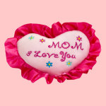 Heart-shaped embroidered pillow with pink ruffle trim and "Mom I Love You" text