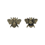 Two small bee-shaped metal charms on a white background