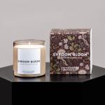 Scented candle in a glass jar beside its floral-patterned box