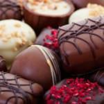 Assorted chocolate truffles with decorative drizzles and toppings