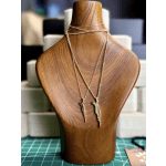 Gold necklaces displayed on a wooden bust stand