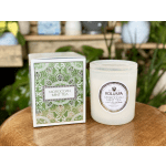 Boxed candle and glass candle jar on a wooden surface