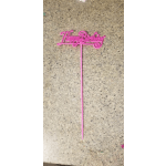 Pink "Happy Birthday" cake topper on a speckled countertop