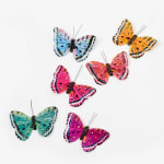 Five colorful butterfly decorations on a white background