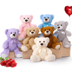Colorful teddy bears on boxes with a small bunch of red roses