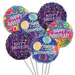 Cluster of colorful anniversary balloons with printed messages