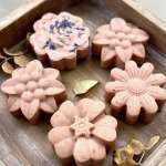 Tray of pink flower-shaped soaps with dried petals