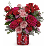 Bouquet of pink and red roses with red daisies in a heart-patterned vase