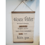 Wooden wall sign with house rules text hanging on a rope