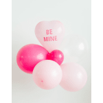 Pink heart balloon with "BE MINE" text and several pink balloons