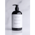 Black pump bottle of hand lotion with a white minimalist label on a light background