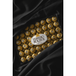 Box of Ferrero Rocher chocolates on black fabric