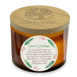 Amber candle in a glass jar with a wooden lid and holiday label