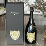 Dom Pérignon champagne bottle beside its black gift box
