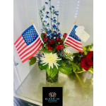 Red and white floral arrangement with two small American flags