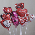Cluster of heart-shaped Valentine's Day balloons on white sticks