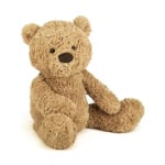 Plush teddy bear sitting on a white background