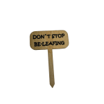 Wooden plant stake with the words "DON'T STOP BE-LEAFING"