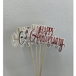Glittery anniversary cake toppers on wooden sticks