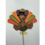 Paper turkey decoration on a stick with colorful feather shapes