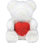 White teddy bear holding a red heart made of roses