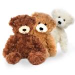Three plush teddy bears in brown, tan, and white