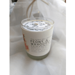 Glass candle jar labeled Peony & Mahogany