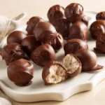 Tray of chocolate truffles, some cut open to show filling