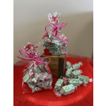 Gift bags of wrapped heart-shaped candies on a red cloth