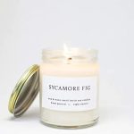 A scented candle in a glass jar with a metal lid