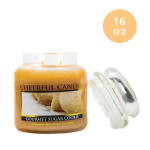 A jar candle labeled Gourmet Sugar Cookie with a glass lid.