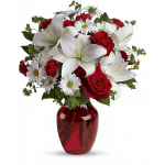 Bouquet of red roses, white lilies, and daisies in a red vase