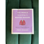 A book with a purple cover lies on green fabric