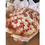 Bouquet of pink and cream roses wrapped in pale pink paper