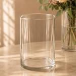Clear cylindrical glass vase on a tabletop