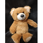 Brown teddy bear plush toy on a dark background