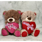 Two plush teddy bears holding heart-patterned bows