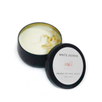 Open black candle tin with white jasmine wax and lid beside it