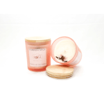 Two pumpkin spice candles in pink glass jars with bamboo lids