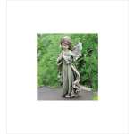 Garden angel statue of a praying child with wings and a flower crown on a stone path