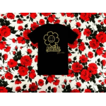 Black T-shirt with a smile graphic on a red floral background